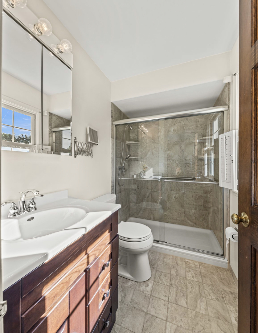 1580 Clemson Drive Naperville, IL 60565 - Photo 26 of 34 a bedroom with a large bed and chandelier