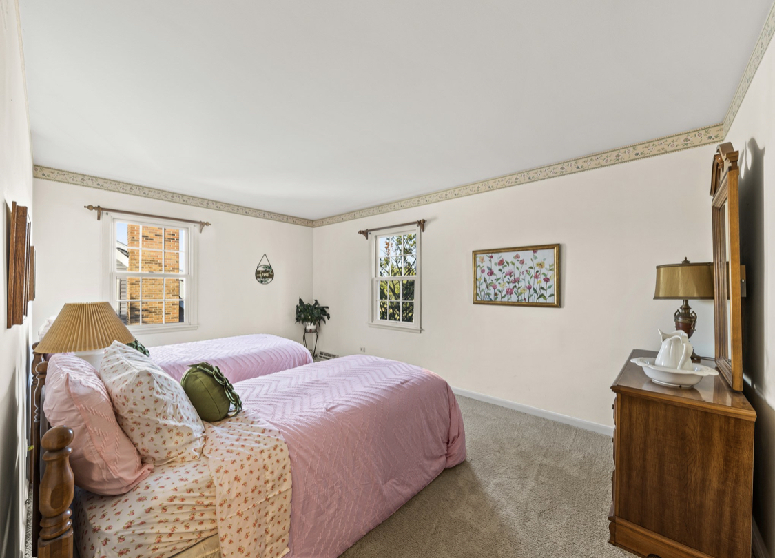 1580 Clemson Drive Naperville, IL 60565 - Photo 30 of 34 a spacious bedroom with a bed and a chandelier