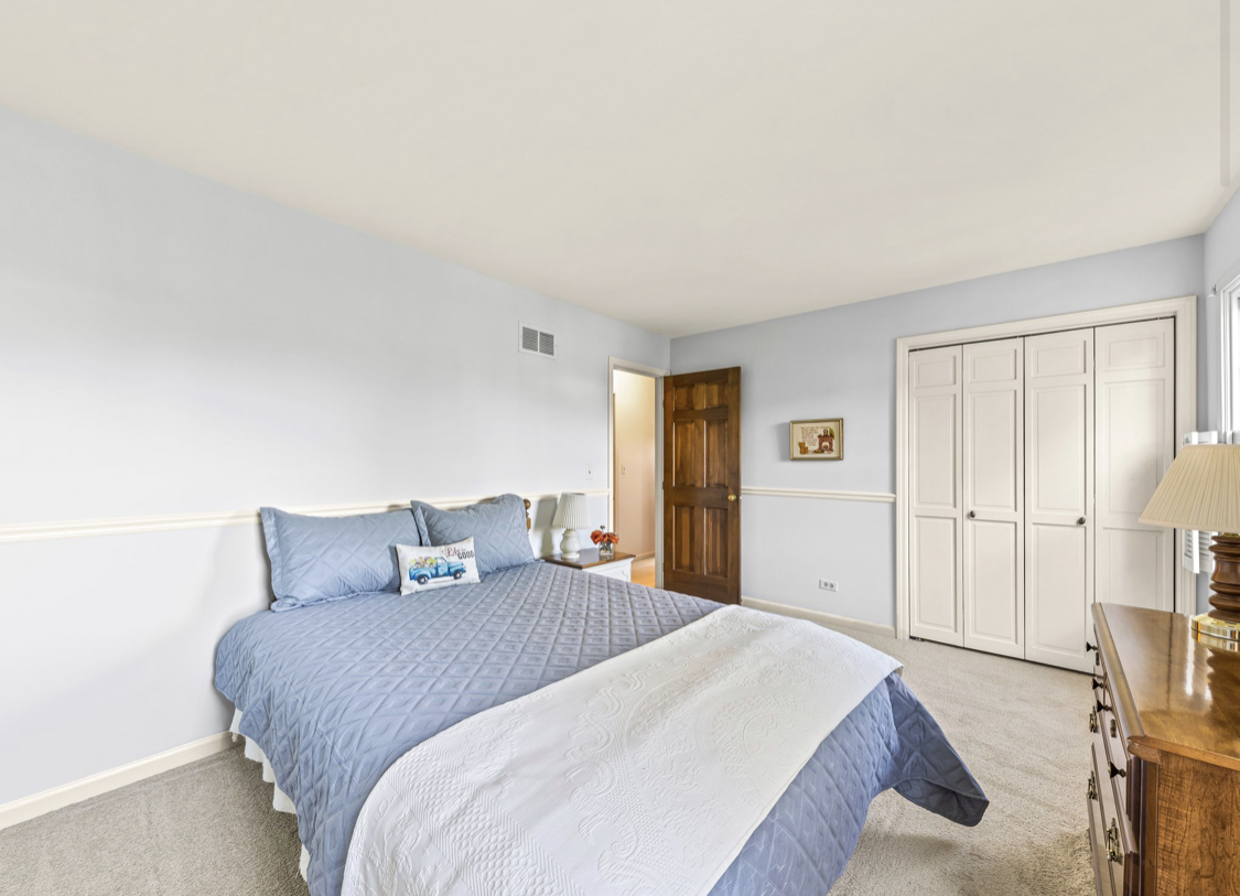 1580 Clemson Drive Naperville, IL 60565 - Photo 32 of 34 a bedroom with a bed and wooden floor