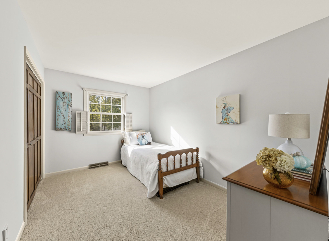 1580 Clemson Drive Naperville, IL 60565 - Photo 34 of 34 a bedroom with a large bed and a chandelier