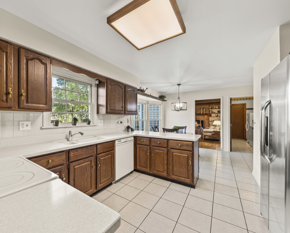 1580 Clemson Drive Naperville, IL 60565 - Photo 10 of 34 a kitchen with stainless steel appliances a sink and a refrigerator