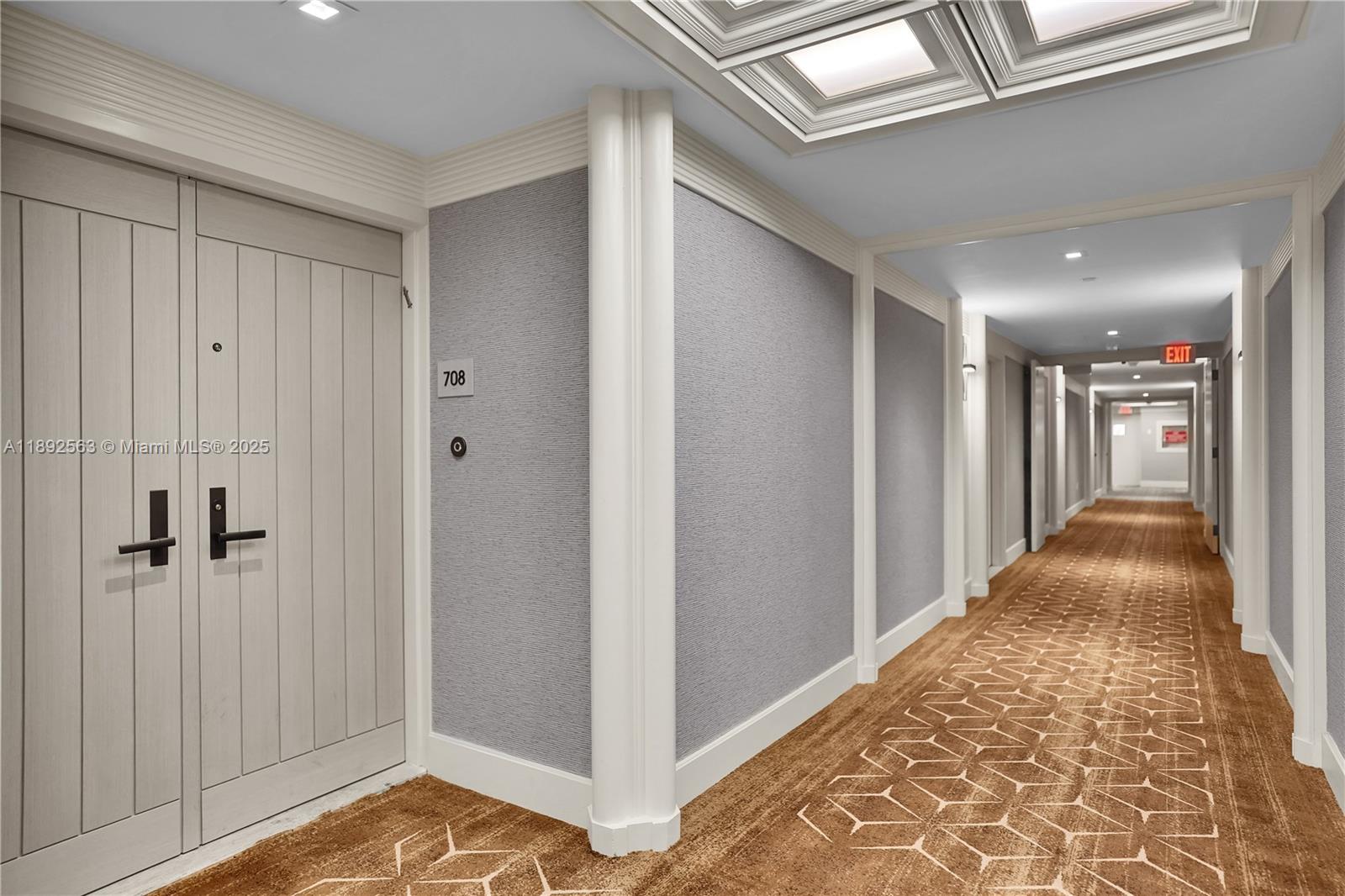 3 Grove Isle Drive, Unit C708 Miami, FL 33133 - Photo 2 of 16 a view of a hallway with wooden floor and staircase