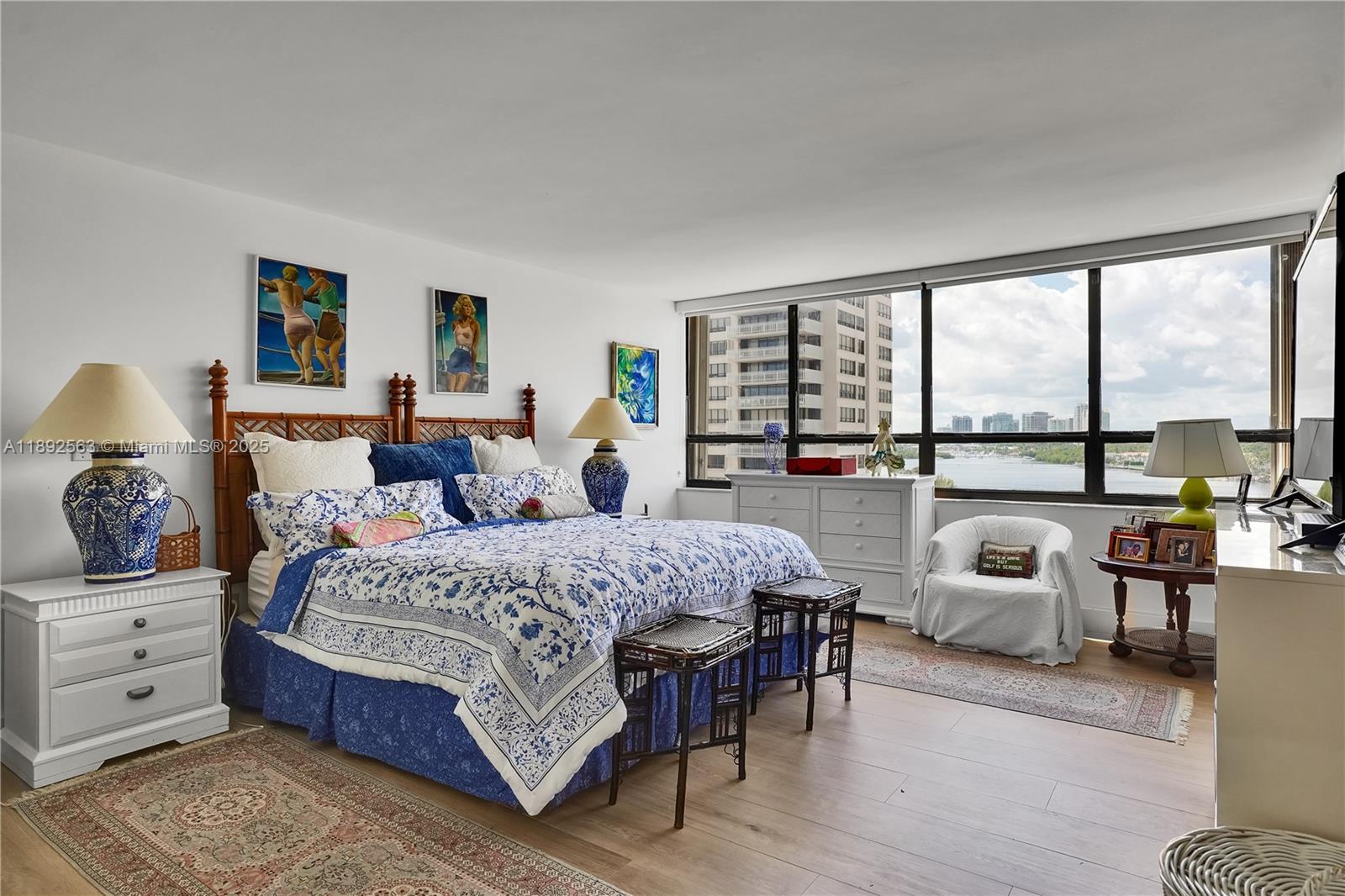 3 Grove Isle Drive, Unit C708 Miami, FL 33133 - Photo 6 of 16 a bedroom with a bed and large windows