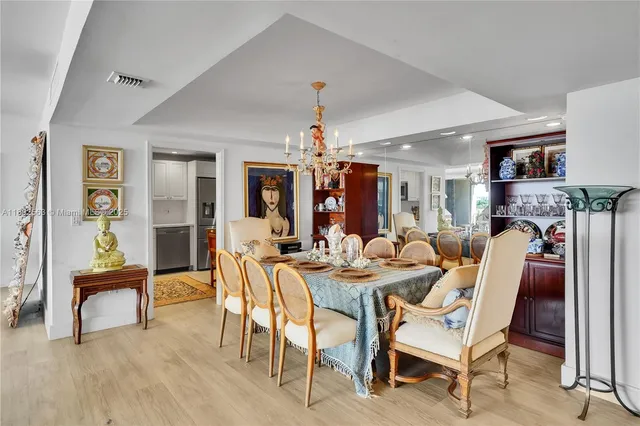 a view of a dining room with furniture wooden floor and chandelier