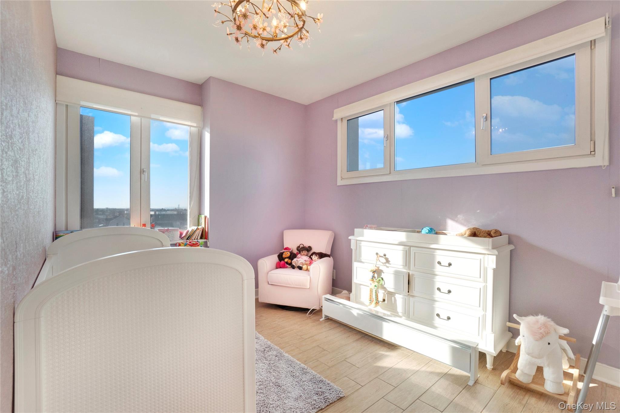 118-20 Ocean Promenade, Unit 5D Queens, NY 11694 - Photo 10 of 17 Bedroom with light wood finished floors and a chandelier