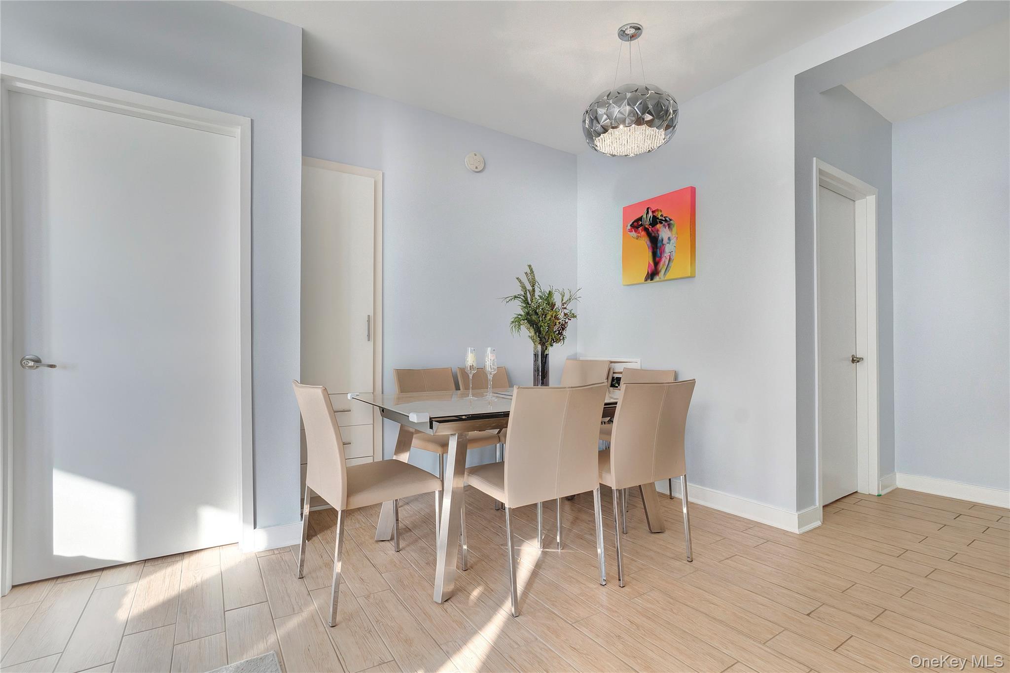 118-20 Ocean Promenade, Unit 5D Queens, NY 11694 - Photo 5 of 17 Dining room with wood finished floors and a chandelier