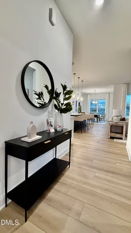 a dining room with furniture a rug and a floor to ceiling window