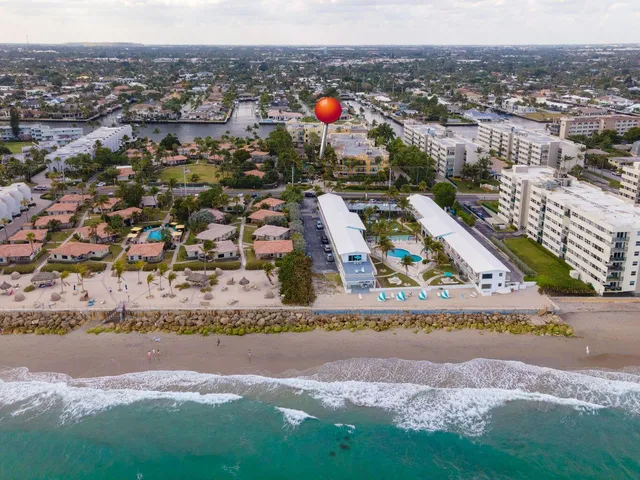an aerial view of residential houses with outdoor space and swimming pool
