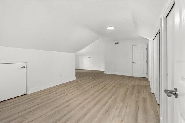 a view of a room with wooden floor