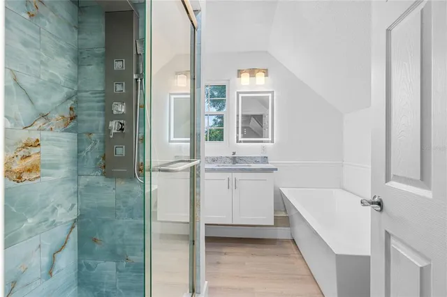 an empty room with wooden floor and a window