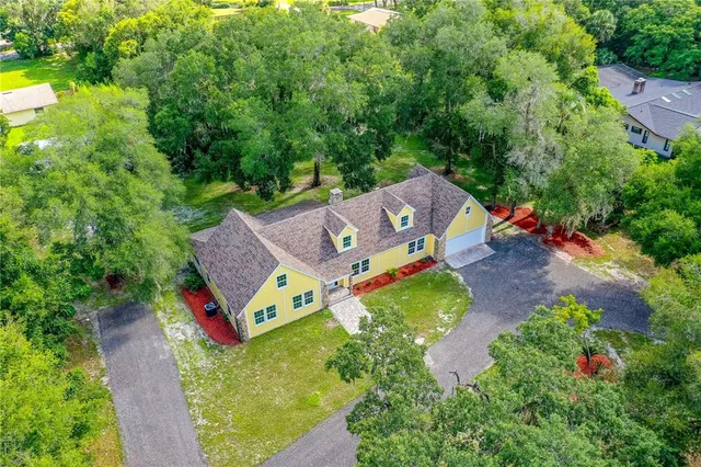 an aerial view of a house with a yard