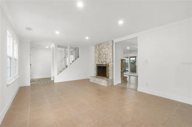 a view of empty room with a fireplace
