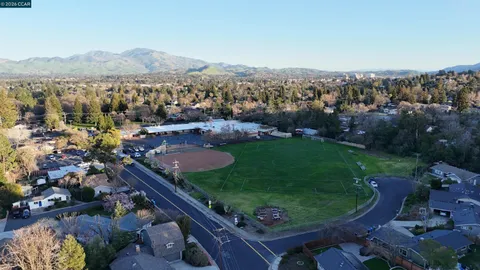 an aerial view of a house with a garden and lake view