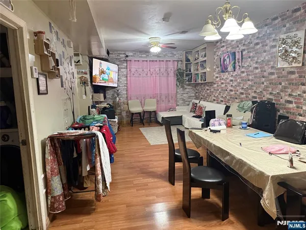 a view of a dining room with furniture and a chandelier