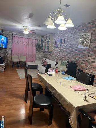 a kitchen with a dining table chairs and a chandelier