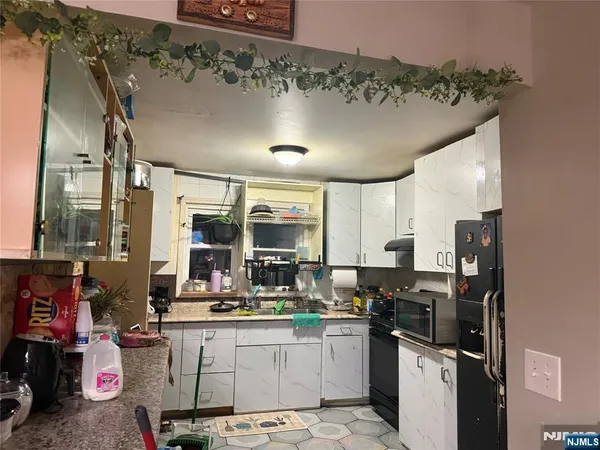 a kitchen with a sink appliances and cabinets
