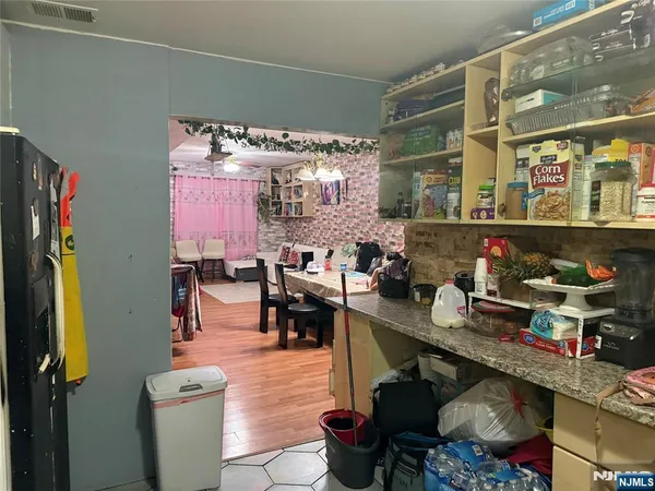 a dining room with lots of furniture and a window