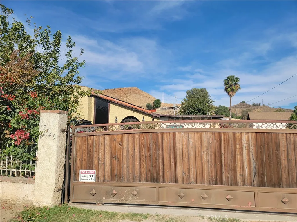 a view of a house with wooden fence