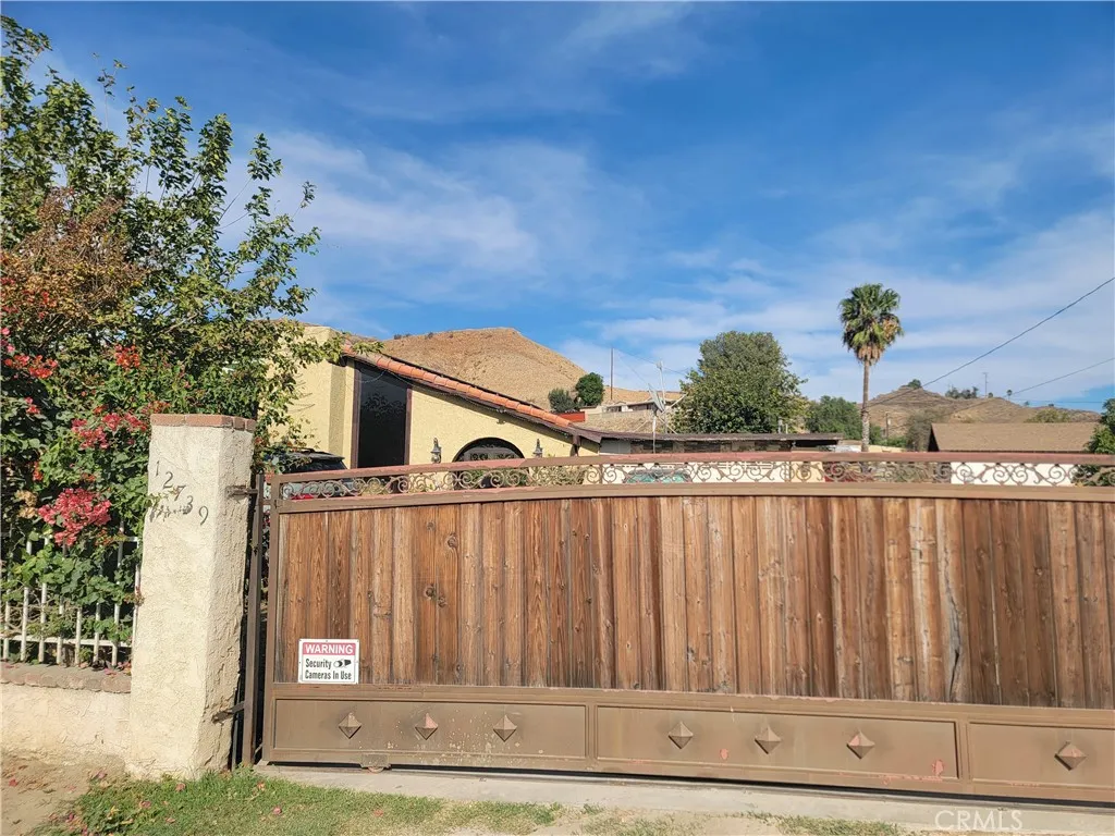 a view of a house with wooden fence