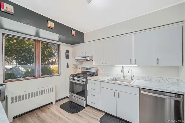 a kitchen with granite countertop white cabinets and white appliances