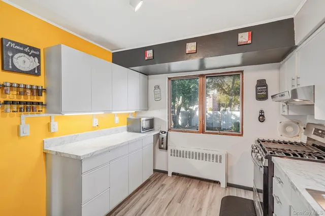 a kitchen with a sink and a large window