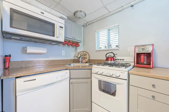 a kitchen with granite countertop a sink stainless steel appliances and cabinets