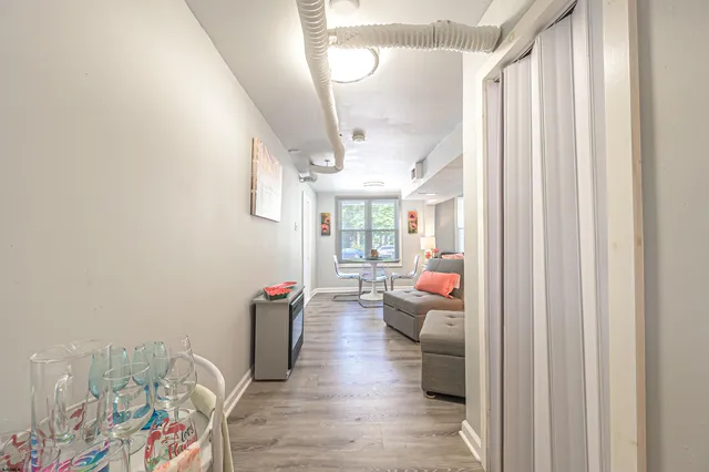 a hallway with furniture and wooden floor