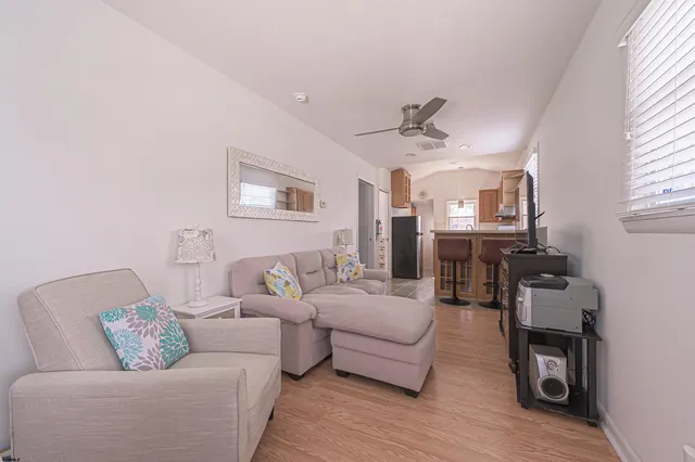 a living room with furniture and a wooden floor