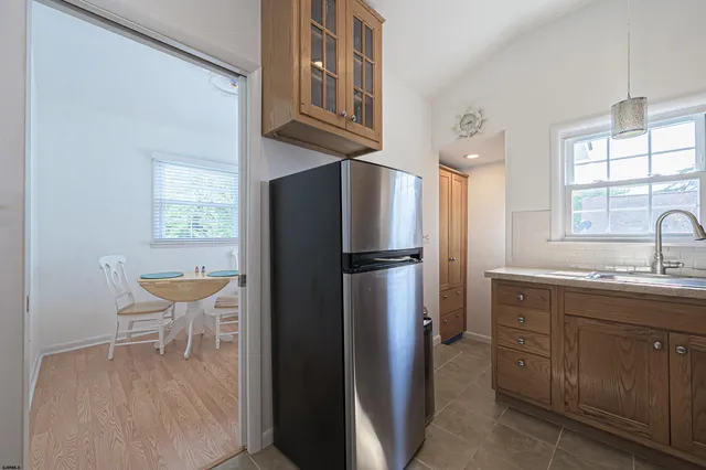 a kitchen with stainless steel appliances a refrigerator and a sink