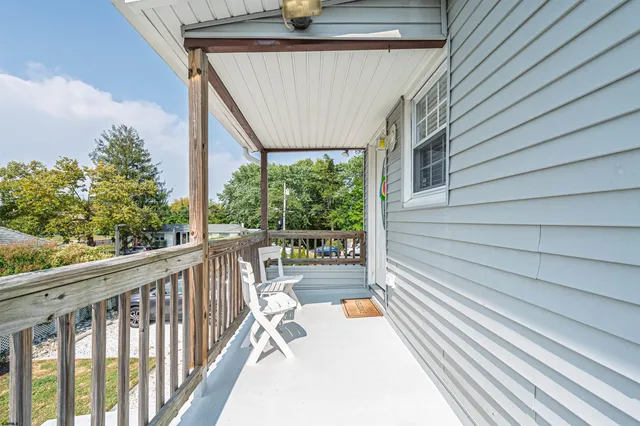 a view of balcony with wooden floor and seating space