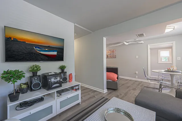 a living room with furniture and flowers