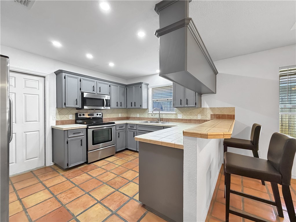 4214 Valley Circle Corpus Christi, TX 78413 - Photo 7 of 28 a kitchen with cabinets and chairs