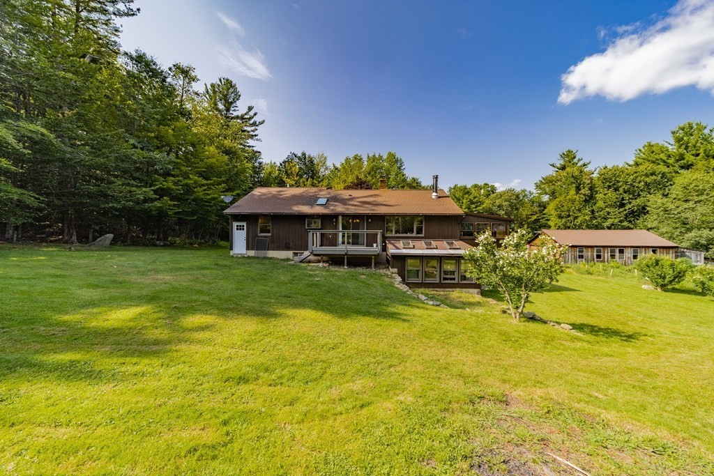 a front view of house with yard and swimming pool