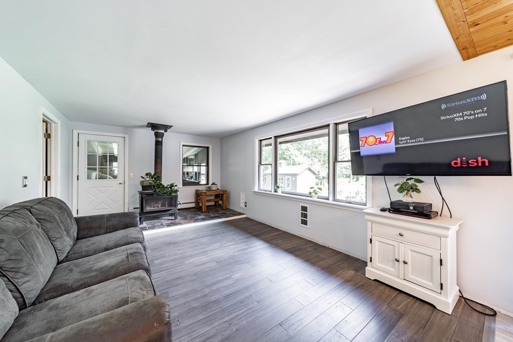 11 Clark Wright Road Middlefield, MA 01011 - Photo 16 of 30 a living room with furniture and a flat screen tv with wooden floor