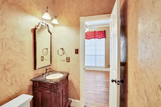 a bathroom with a sink a mirror a vanity and shower