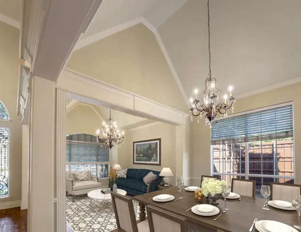 a view of a dining room with furniture wooden floor and chandelier
