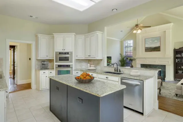 a kitchen with a sink a stove and cabinets