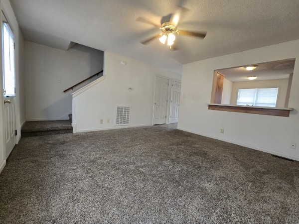 235 State Line Road Oak Grove, KY 42262 - Photo 9 of 18 an empty room with a chandelier fan and windows