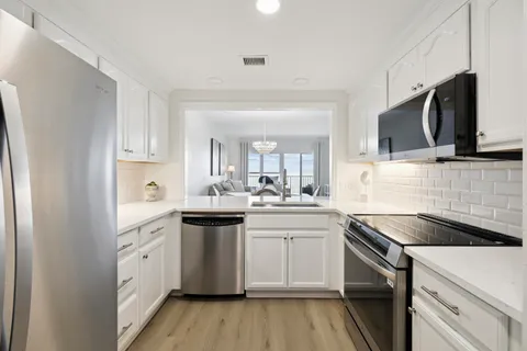 a kitchen with a sink stove and microwave