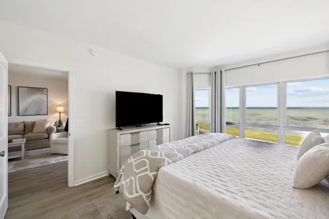a view of a bedroom with a bed and balcony