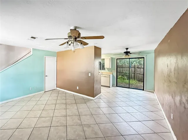 a view of a livingroom with a ceiling fan and window