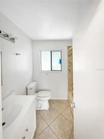 a bathroom with a toilet a sink and bathtub