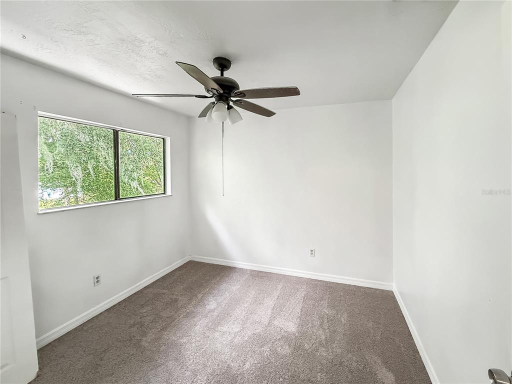 322 Canal Road, Unit G41 Edgewater, FL 32132 - Photo 10 of 14 an empty room with windows and fan