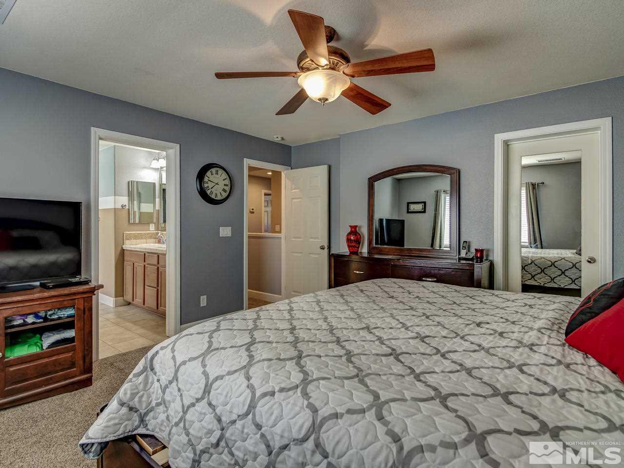 1990 Black Sand Drive Reno, NV 89521 - Photo 12 of 25 a bedroom with a bed and a flat screen tv