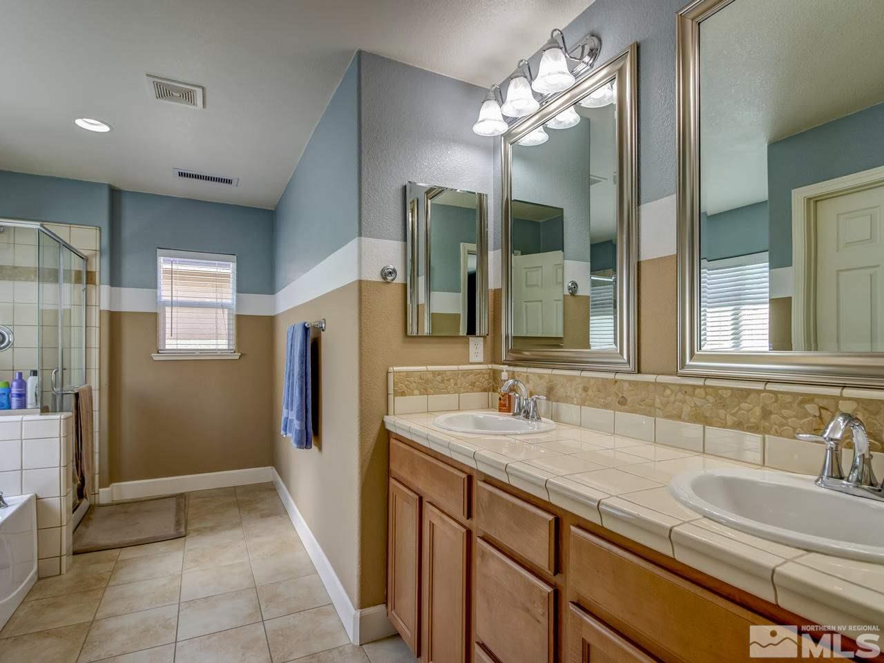1990 Black Sand Drive Reno, NV 89521 - Photo 13 of 25 a bathroom with double vanity sink and a mirror