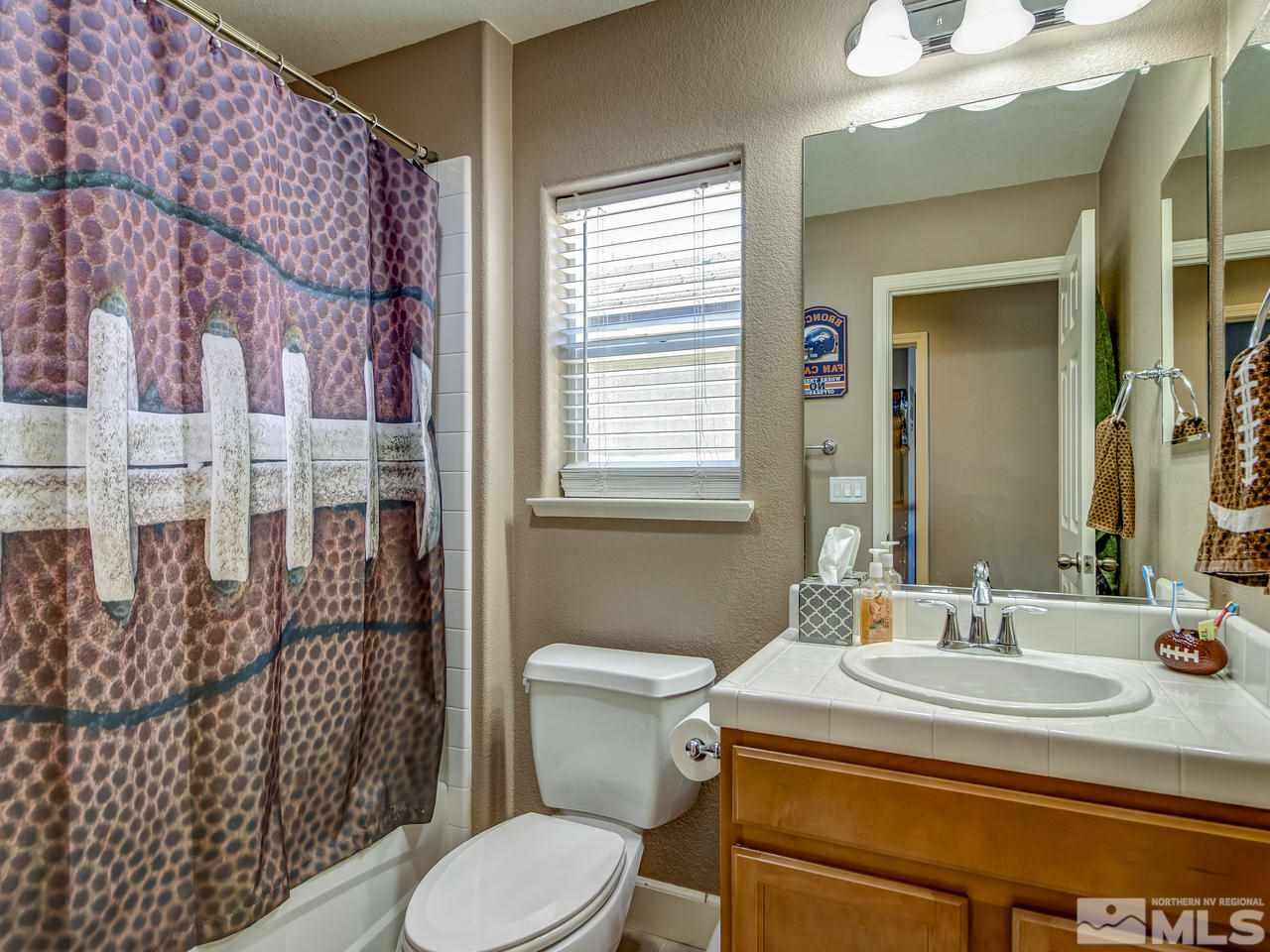 1990 Black Sand Drive Reno, NV 89521 - Photo 16 of 25 a bathroom with a sink toilet and shower