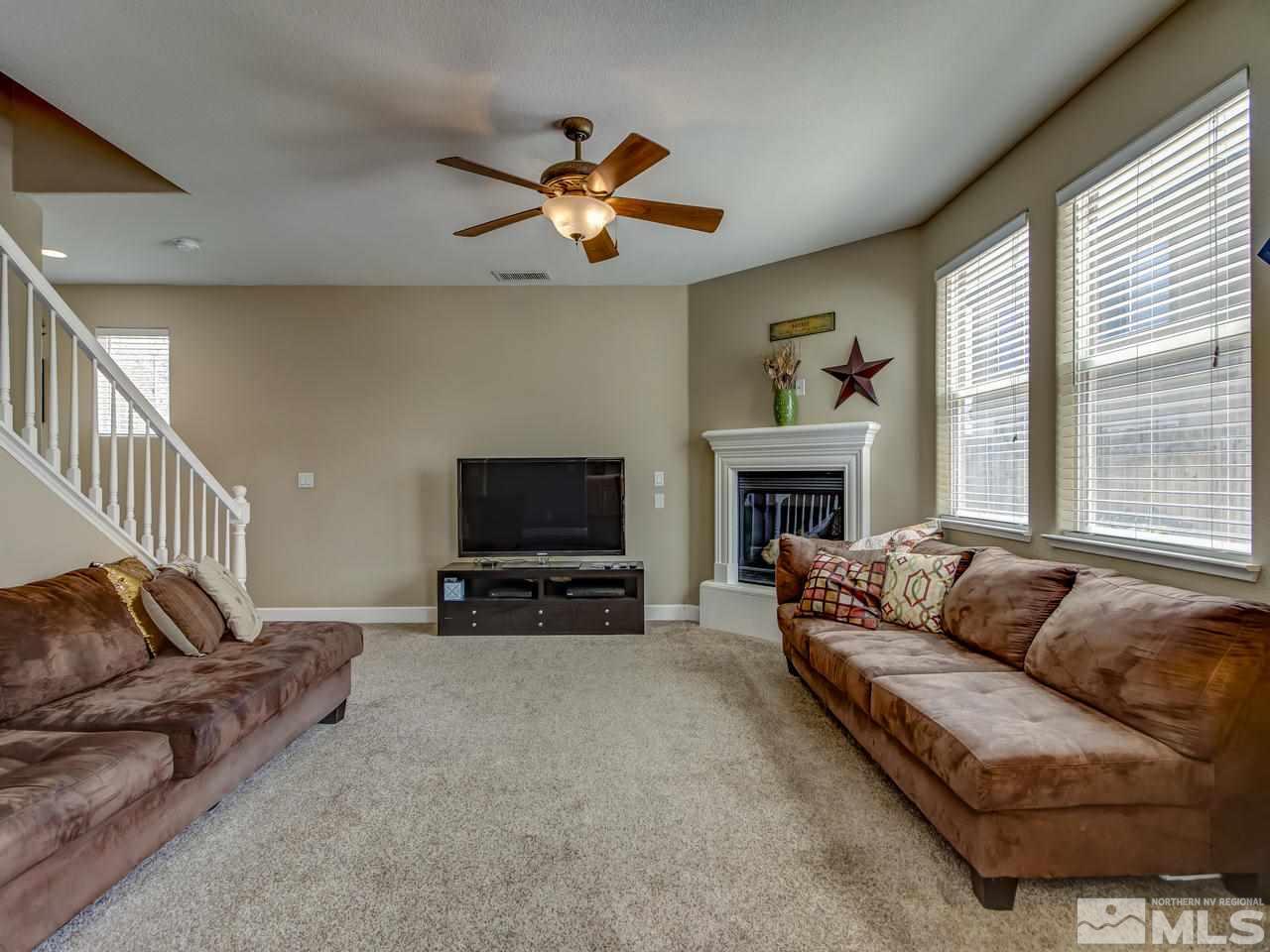 1990 Black Sand Drive Reno, NV 89521 - Photo 5 of 25 a living room with furniture a fireplace and a flat screen tv