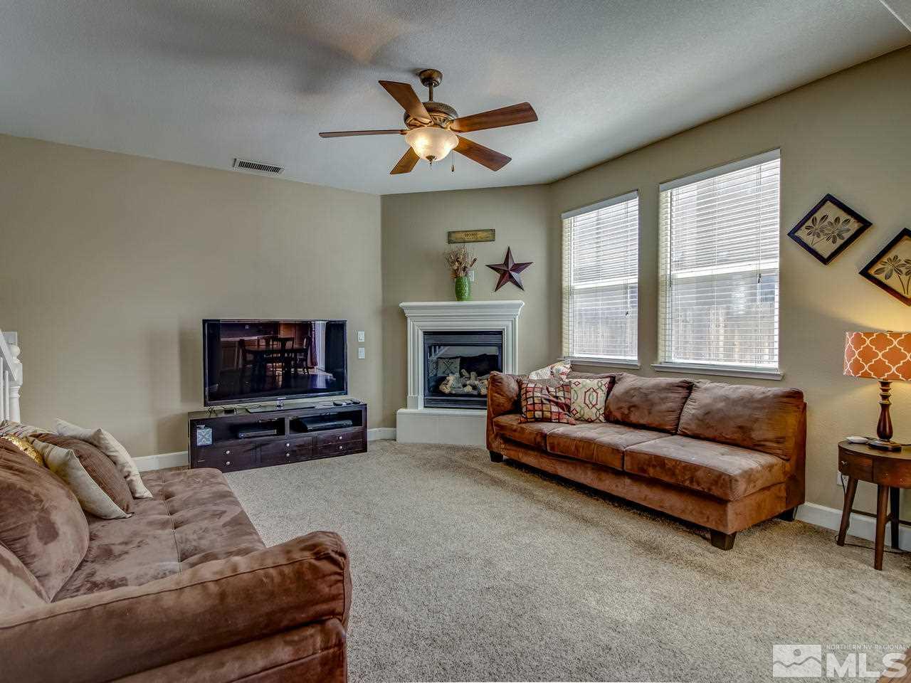 1990 Black Sand Drive Reno, NV 89521 - Photo 6 of 25 a living room with furniture a fireplace and a flat screen tv