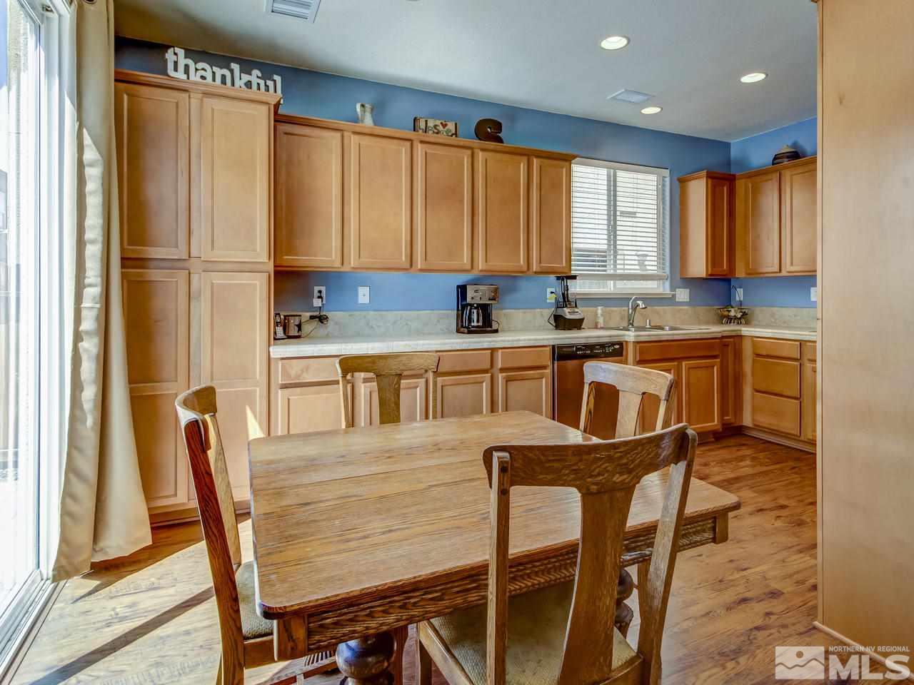 1990 Black Sand Drive Reno, NV 89521 - Photo 7 of 25 a kitchen with a table chairs sink and cabinets
