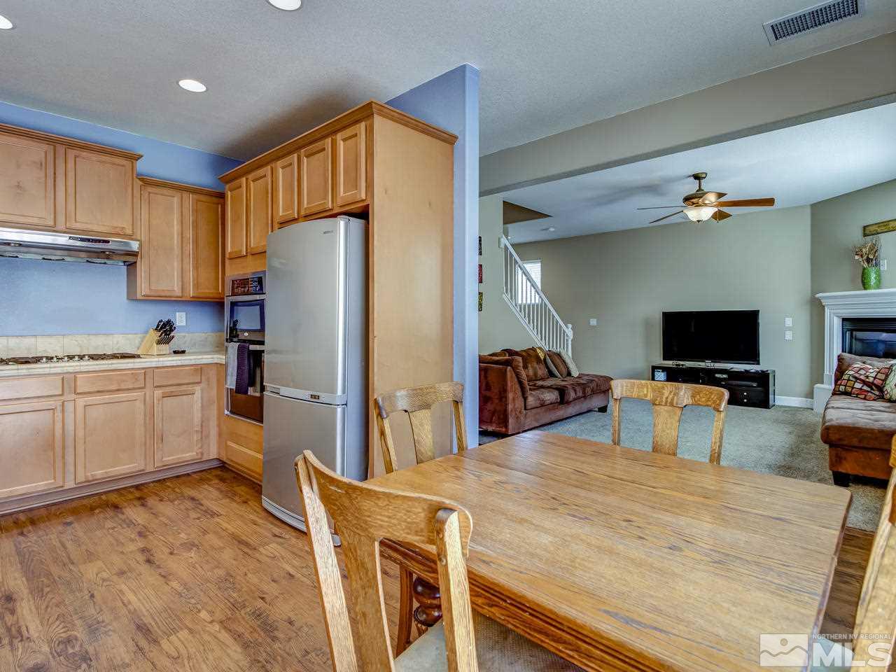1990 Black Sand Drive Reno, NV 89521 - Photo 8 of 25 a kitchen with stainless steel appliances wooden floor and a refrigerator